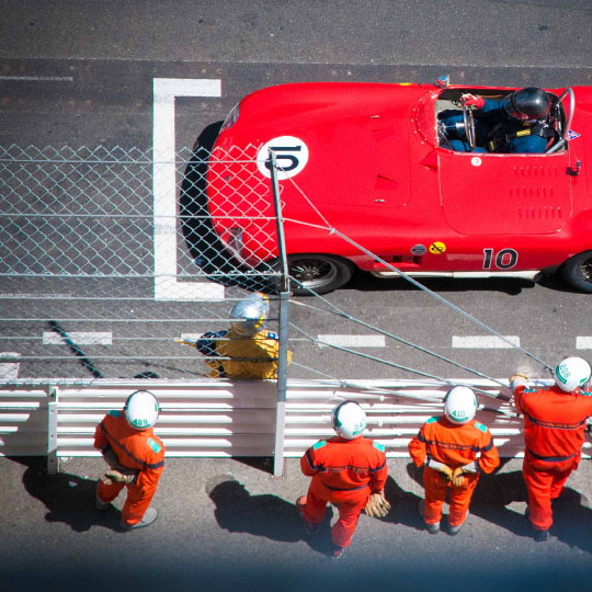 Vintage car and its team on the circuit